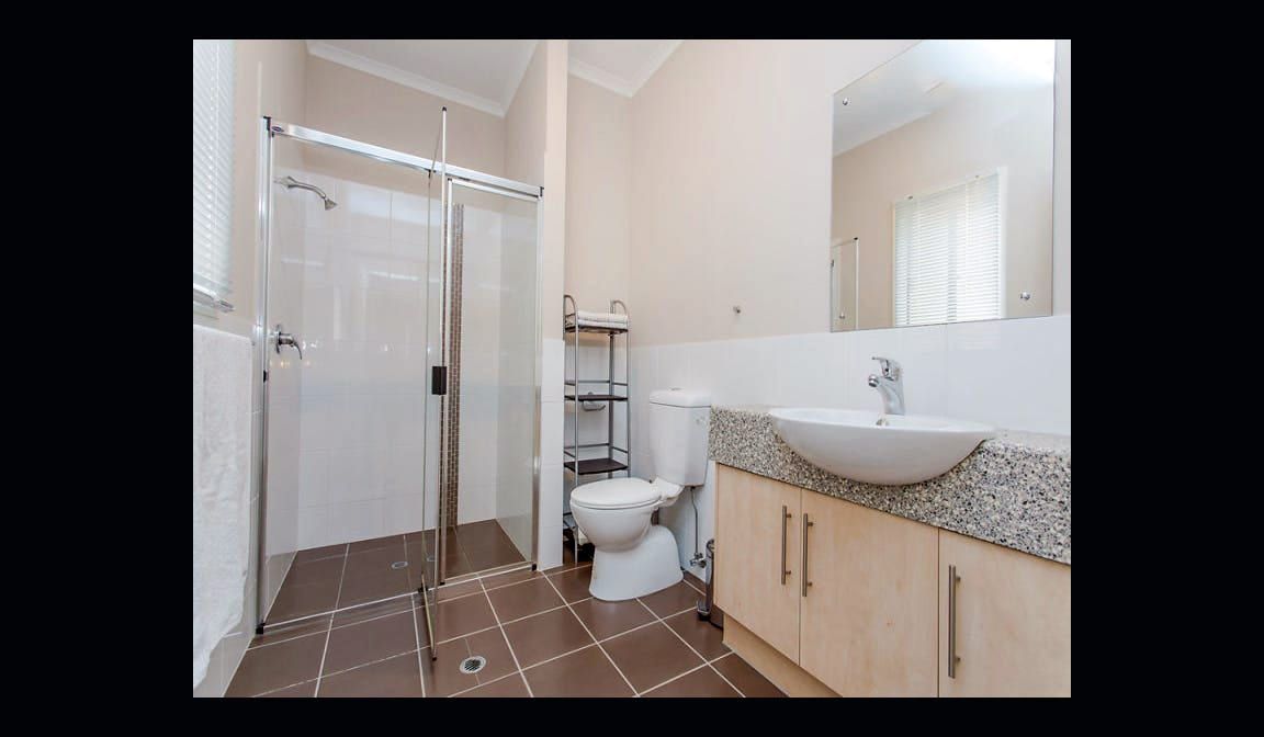 The main bathroom at Condamine Street, with a large shower, vanity and separate toilet