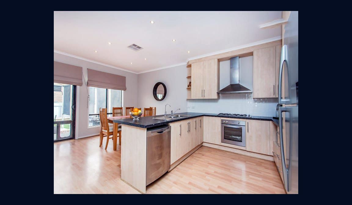 The kitchen at Condamine Street, with a breakfast bar and a window over the sink