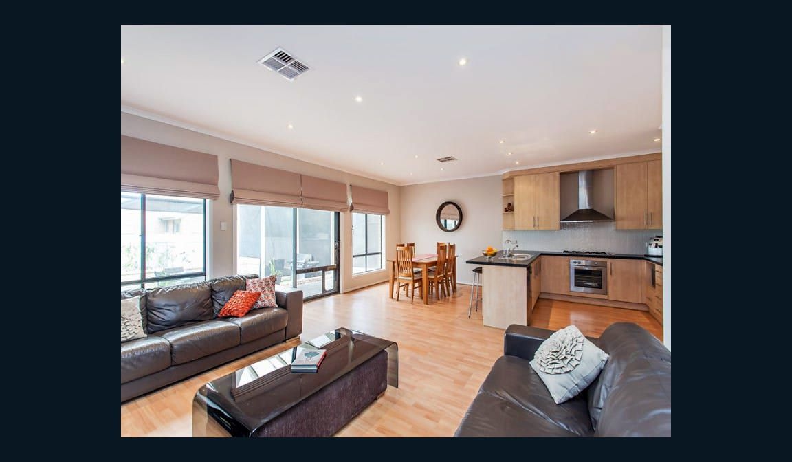 The open-plan living and dining area at Condamine Street, looking through to the kitchen