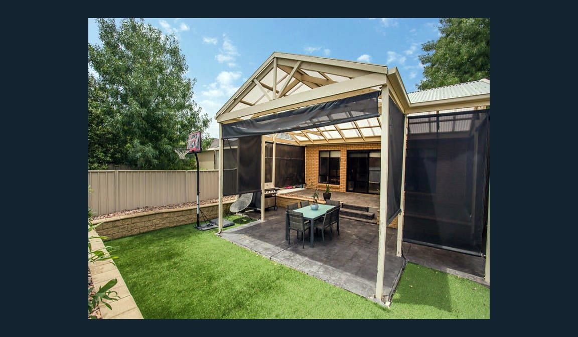 The covered pergola at the rear of the Condamine Street home, with an outdoor table and lawn