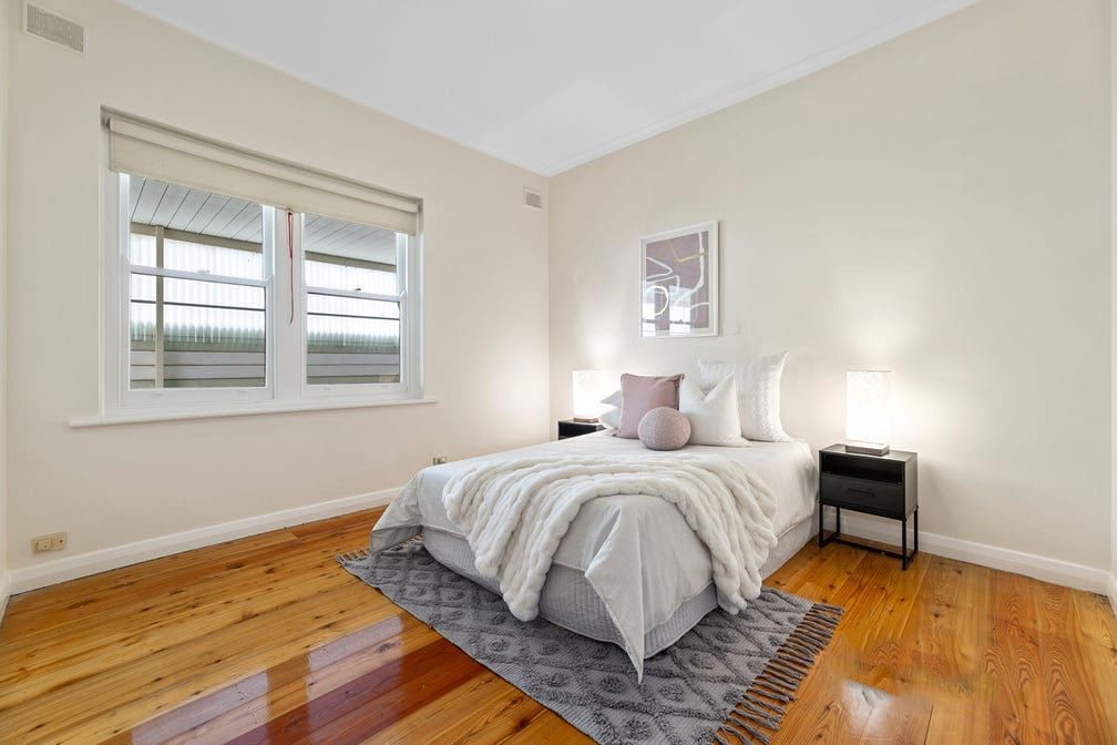 A bedroom at Colton Avenue, with timber floors and a window to the front garden