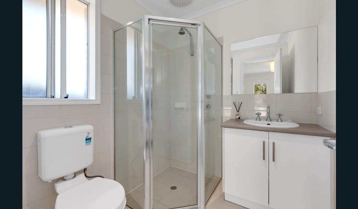 The bathroom at Peerless Road, with a corner shower and vanity