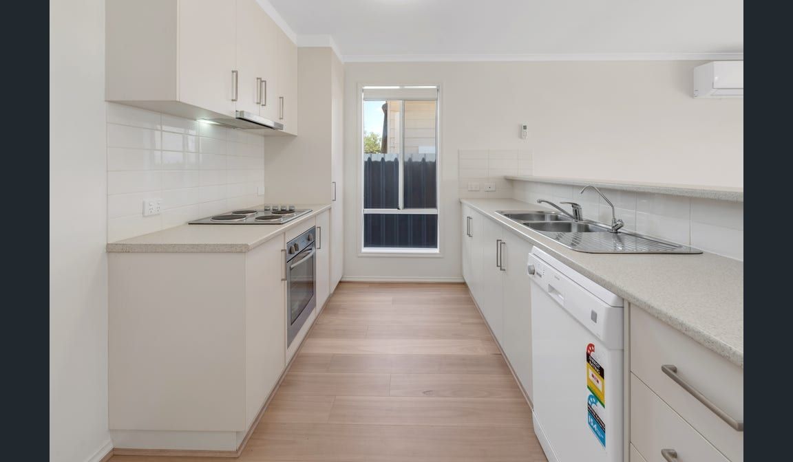 The kitchen at Peerless Road, with a galley layout and a window above the sink
