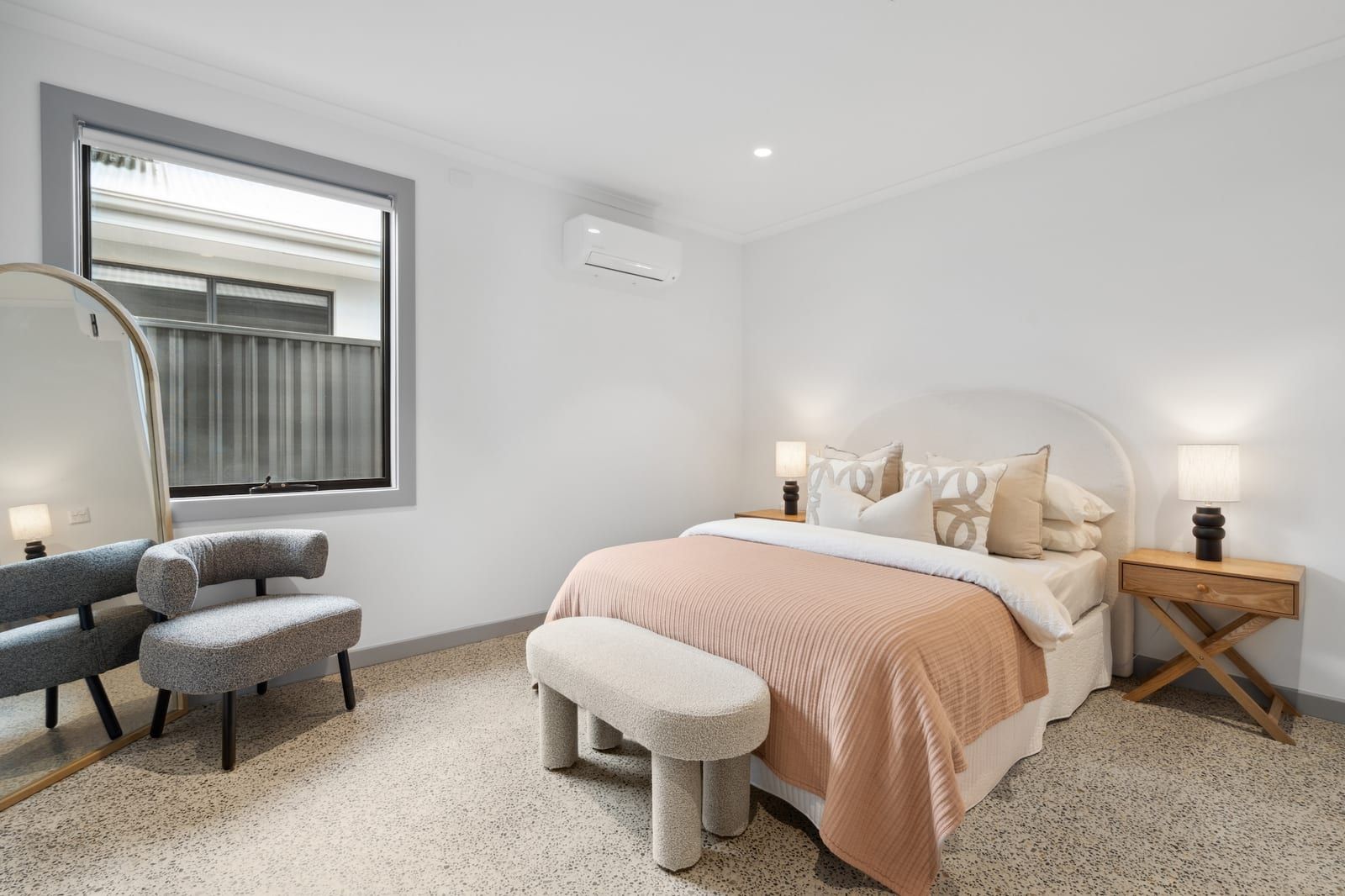 A bedroom at Wyndham Road, with a window to the garden and reverse-cycle air conditioning