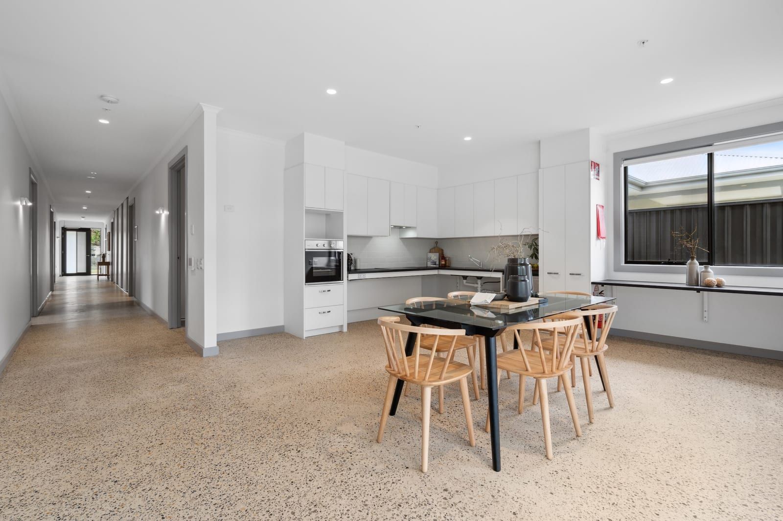 The kitchen and dining area at Wyndham Road, with wide clear floor space between benches